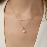 A close up of the crown jewels jumble on a classic bead chain on a model.