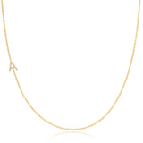 A gold necklace with a pave letter A charm on a white background.