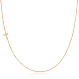 A rose gold necklace with a pave letter T charm on a white background.