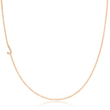 A rose gold necklace with a pave letter J charm on a white background.