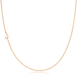 A rose gold necklace with a J letter charm on a white background.