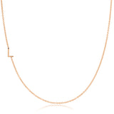 A rose gold necklace with a L letter charm on a white background.