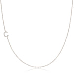 A white gold necklace with a pave letter C charm on a white background.