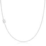 A white gold necklace with a B letter pave charm on a white background.