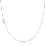 A white gold necklace with a letter K pave charm on a white background.