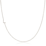 A white gold necklace with a letter L pave charm on a white background.