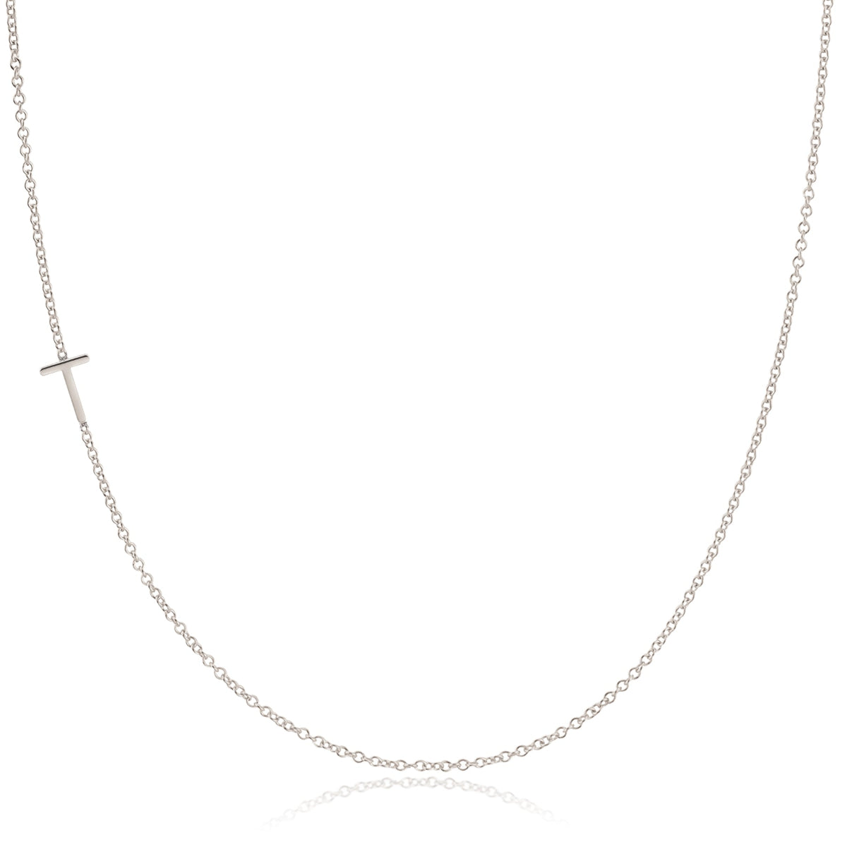 A white gold necklace with a T letter charm on a white background.