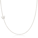 A white gold necklace with a letter W pave charm on a white background.