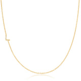 A yellow gold necklace with a pave letter L charm on a white background.