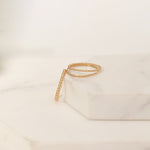 Yellow gold Delicate Trio Stacking Rings laid on a white marble surface and background. 