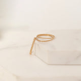 Yellow gold Delicate Trio Stacking Rings laid on a white marble surface and background. 