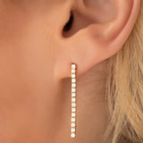 Close-up of a Down the Line Earring shown on a blonde woman's ear. 