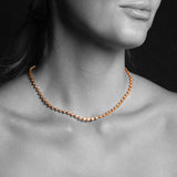 Close-up of a woman's neck wearing The Ultimate Diamond Necklace. 