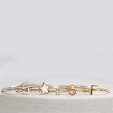 Five gold rings, including two Letter Rings (C and F), a Number 5 Ring, a Twinkle Twinkle Ring and a Birthstone Ring.