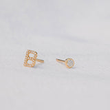 A Pavé Monogram Earring Set in the letter B in yellow gold on a light grey background. 