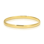 A gold vermeil For Keeps Bangle on a white background. 