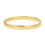A gold vermeil For Keeps Bangle on a white background. 