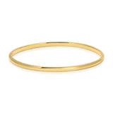 A vermeil gold Flirt Bangle on a white background. 