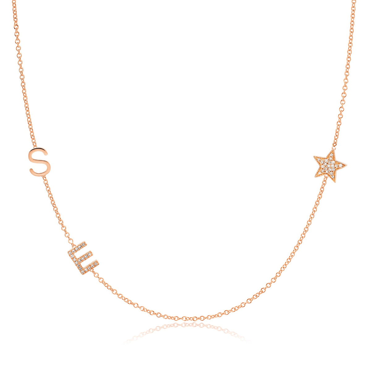A Custom Gold Necklace in rose gold with two letter charms, a pavé E and an S positioned on the left side of the necklace, and a pavé star on the right side, on a white background.