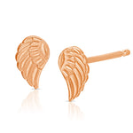 A pair of Charm Studs - Angel Wing in rose gold on a white background. 