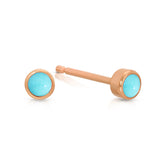 A pair of Birthstone Studs - Turquoise (December) in rose gold on a white background.