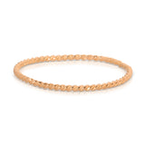 A Delicate Twist Band in rose gold on a white background. 