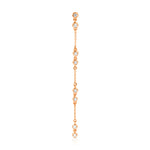 A Stardust Earring in rose gold on a white background. 