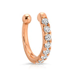 A Pavé Ear Cuff in rose gold on a white background. 