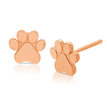 A pair of Charm Studs - Paw in rose gold on a white background.