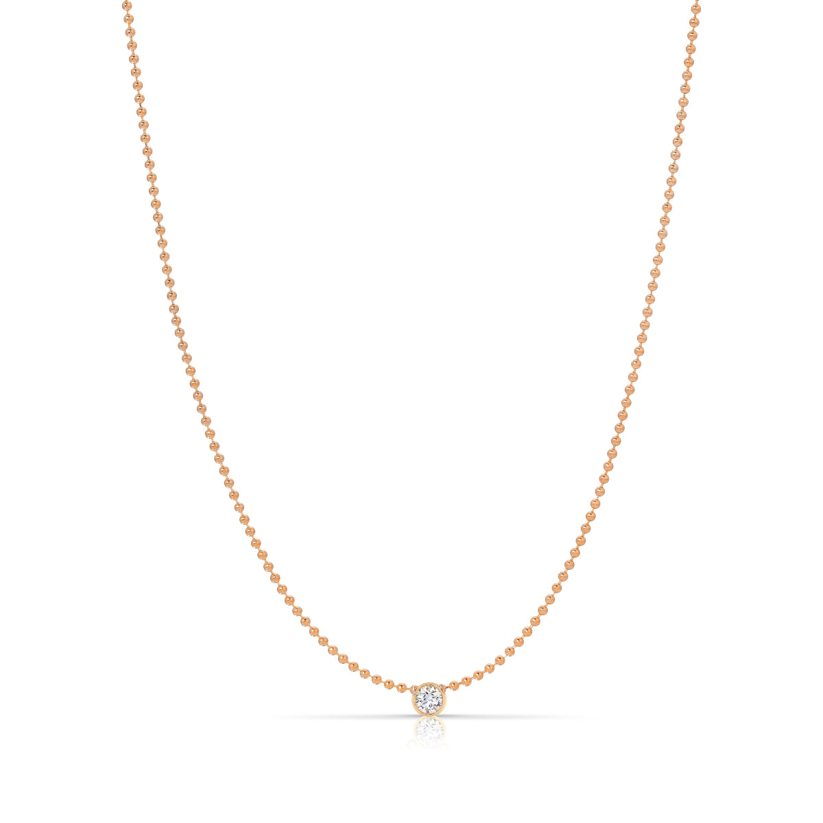 A Single Diamond Layering Necklace in rose gold on a white background. 
