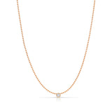 A Single Diamond Layering Necklace in rose gold on a white background. 