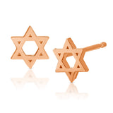 A pair of Charm Studs - Star of David in rose gold on a white background.