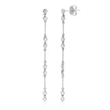 A pair of Stardust Earrings in white gold on a white background. 