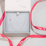 A Pavé Monogram Necklace with Diamond and a M charm in a Maya Brenner jewellery box. 