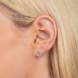 Close-up of a Charm Stud - Recovery in white gold  in a blonde woman's ear. 