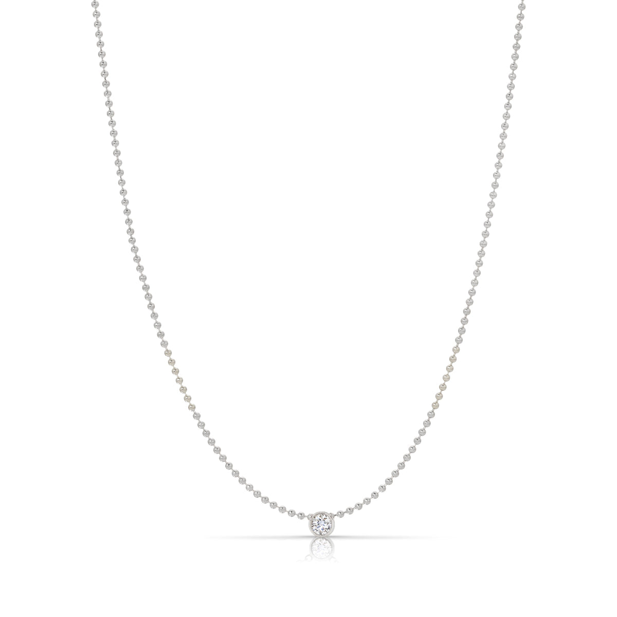 A Single Diamond Layering Necklace in white gold on a white background. 