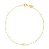 A yellow gold Lip Bracelet on a white background. 