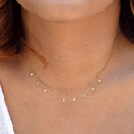 A close-up of a neck wearing a Stardust Diamond Necklace. 
