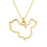 A China pendant necklace in yellow gold with a diamond on a white background.