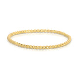 A Delicate Twist Band in yellow gold on a white background. 