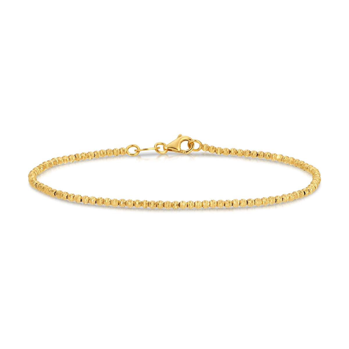 A Diamond Cut Bracelet in yellow gold on a white background. 