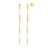 A pair of Stardust Earrings in yellow gold on a white background. 
