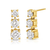 A Triple Sec Diamond Earring in yellow gold on a white background. 