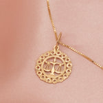 The Zodiac Necklace - Libra on a peach silk background. 