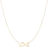 A LOVE Necklace in yellow gold on a cable chain on a white background. 