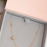 A Monogram Necklace with Heart Yellow Gold and a letter J charm in a Maya Brenner jewellery box. 
