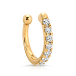 A Pavé Ear Cuff in yellow gold on a white background. 