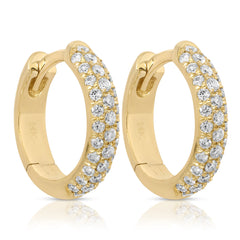 A pair of Pavé Huggies on a white background. 