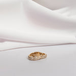 A pair of Pavé Huggies on a white background. 