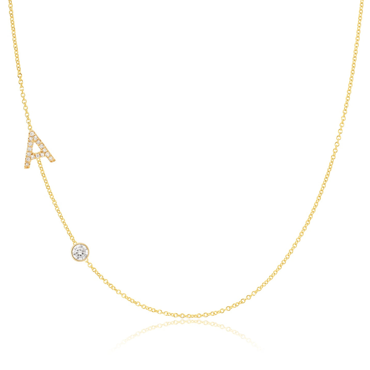 A Pavé Monogram Necklace with Diamond  and a letter A charm in yellow gold on a white background.